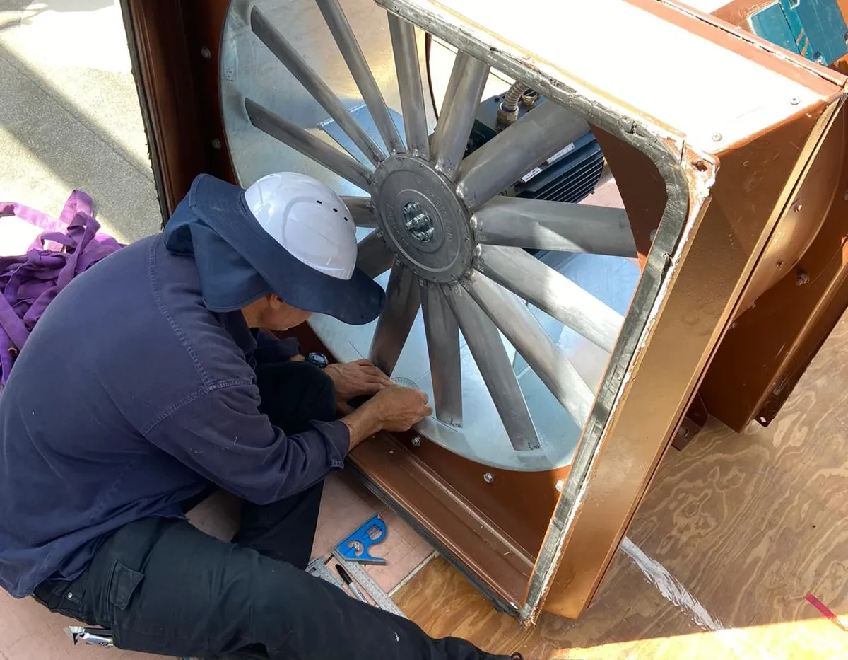 Eclipse technician working on a large industrial exhaust fan