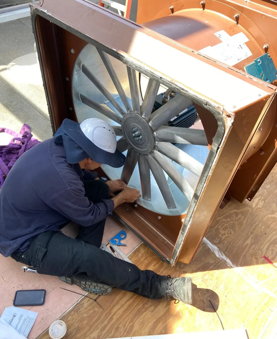 Eclipse technician working on a large industrial exhaust fan