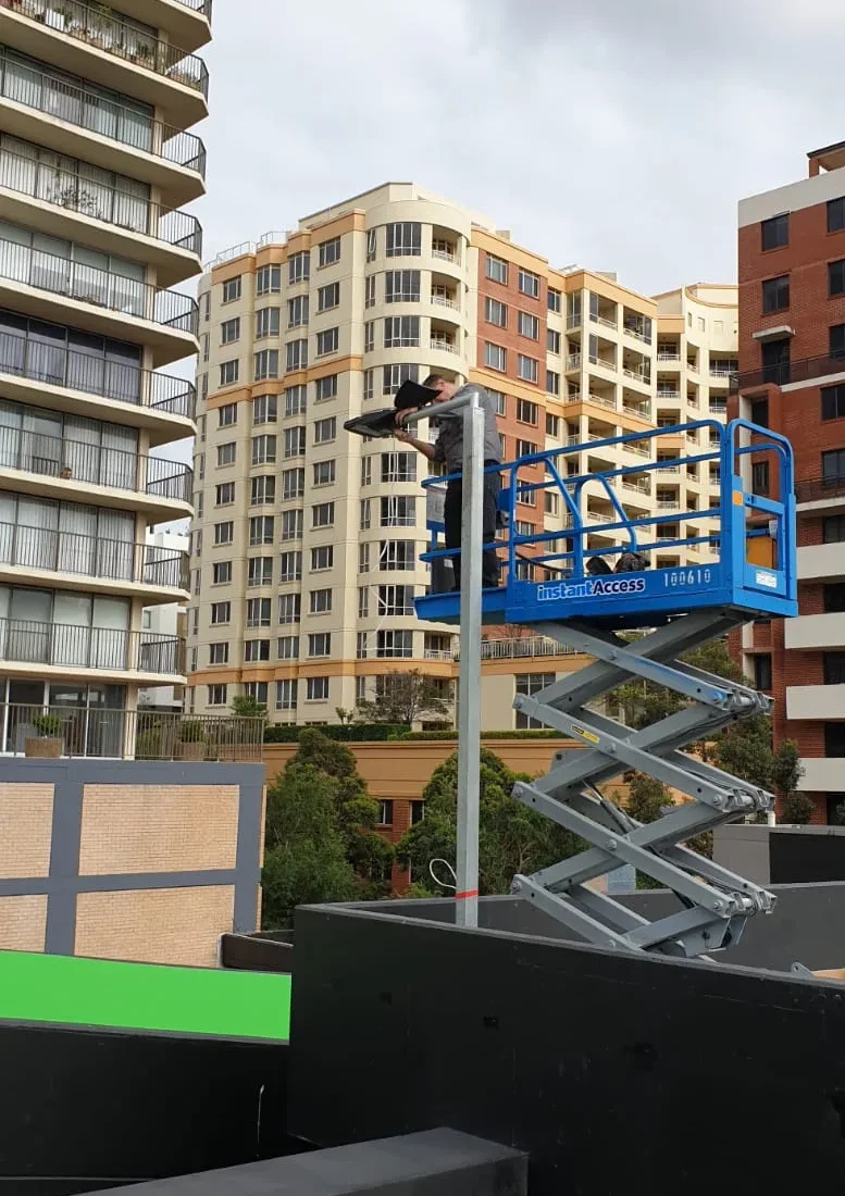 Scissor lift on the roof of a high-rise strata building