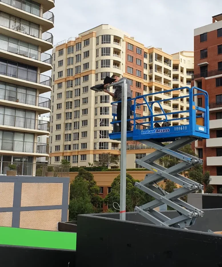 Scissor lift on the roof of a high-rise strata building