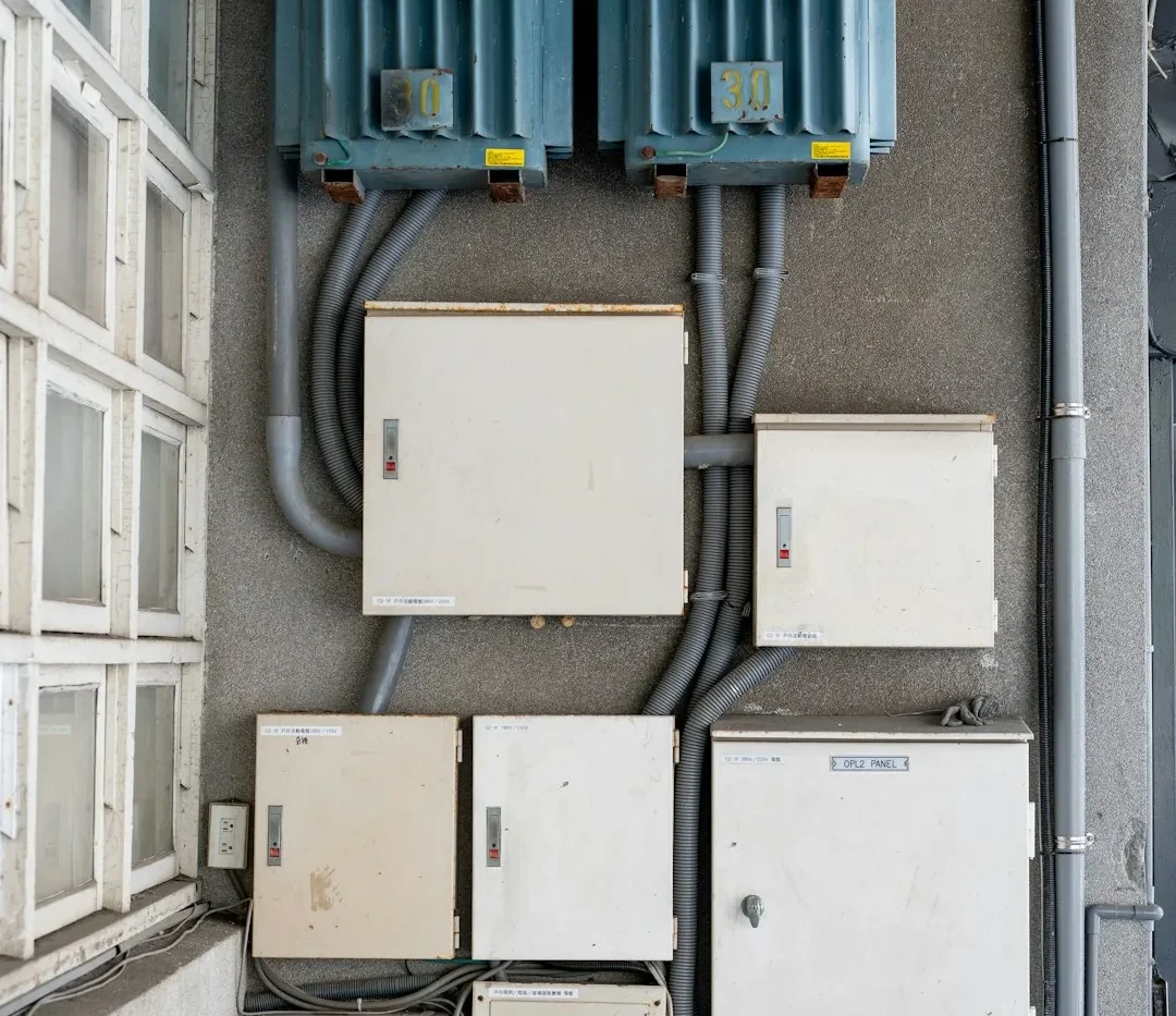 Older electrical distribution boards and transformers on a wall